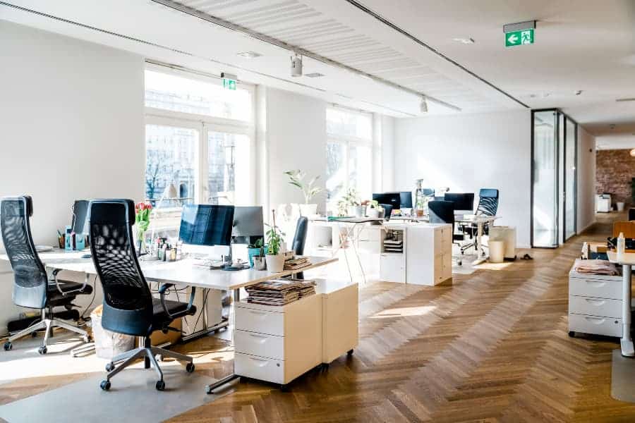 Office with white desks and black chairs